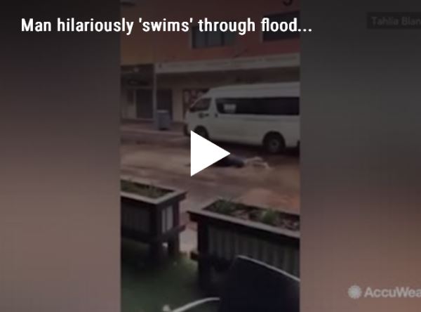 Man hilariously 'swims' through flood...video